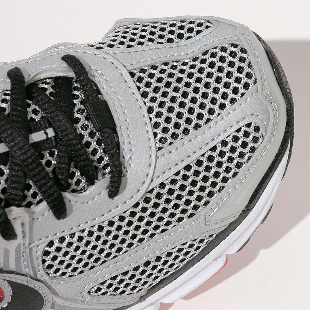 Detailed view of the forefoot mesh and layered paneling on the Nike Zoom Vomero 5 for breathability and structure.