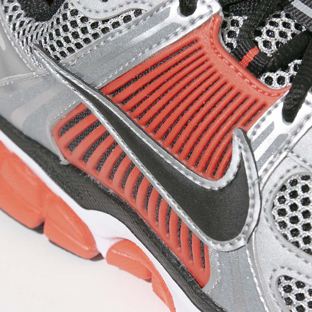 Zoomed-in view of the Nike Swoosh and side cage support design on the Vomero 5.